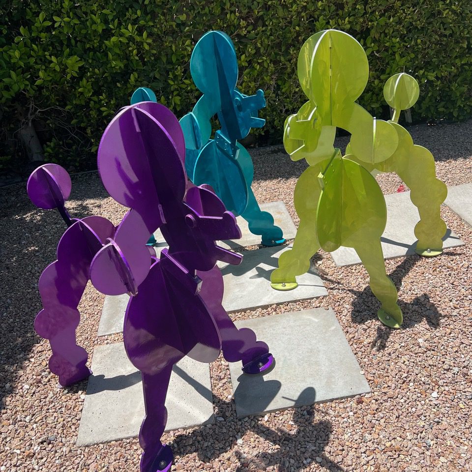 Photo of Steel Poodle Sculptures in Chartreuse, Purple and Turquoise by Karen and Tony Barone